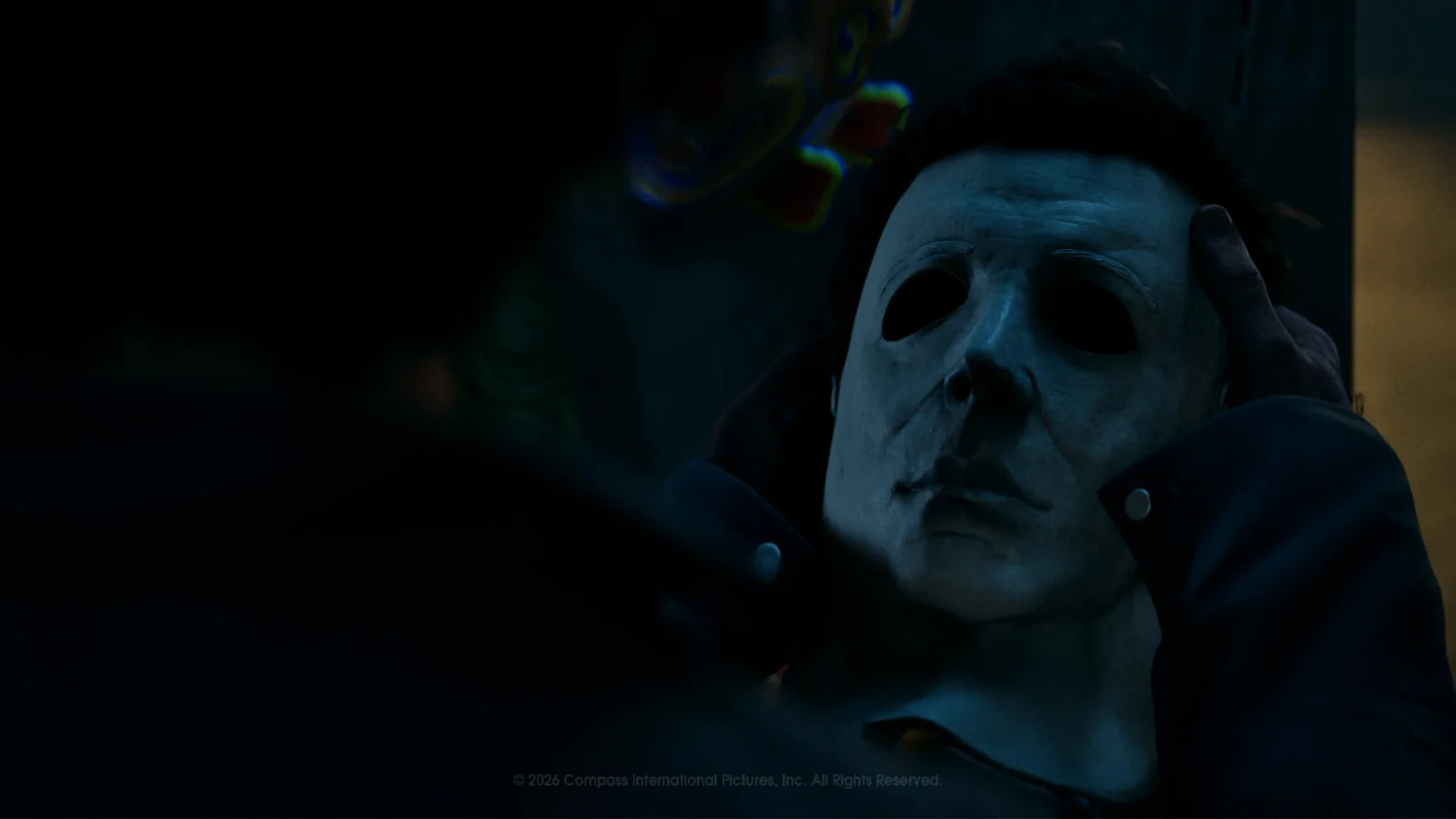 Close-up of Michael Myers adjusting his mask