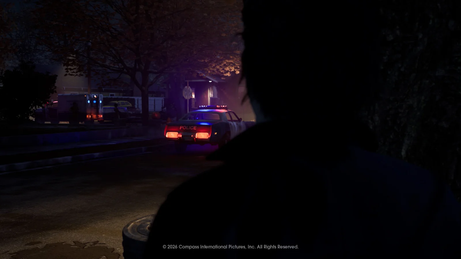 Michael Myers watching police vehicles on a dark Haddonfield street